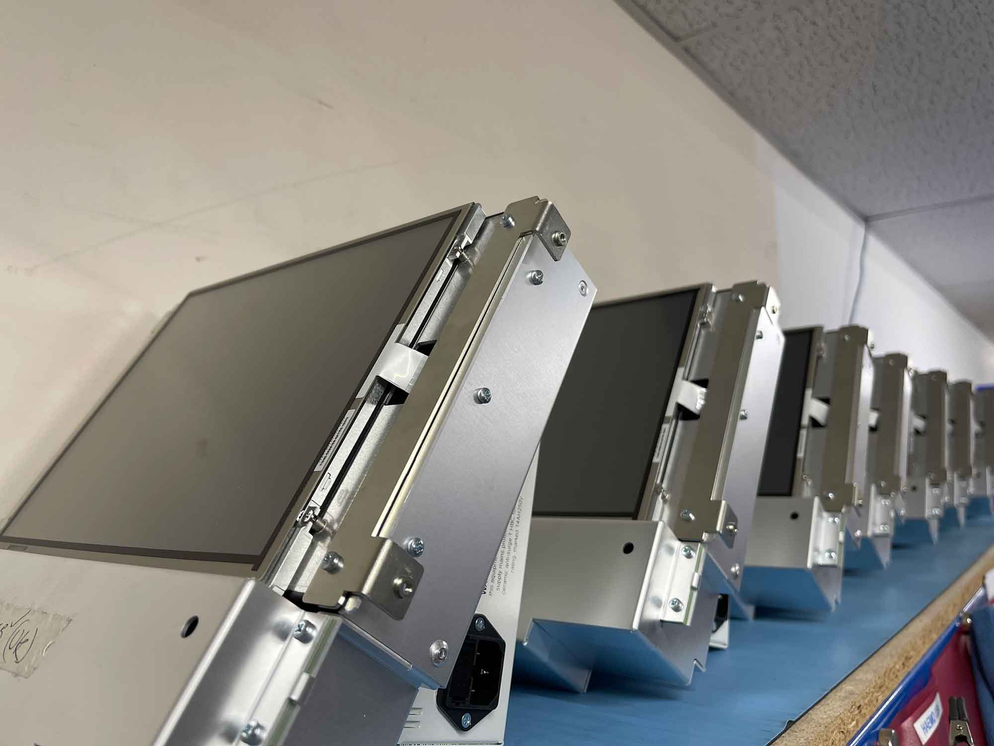 A close up of a line of BloodTrack kiosk screens. 